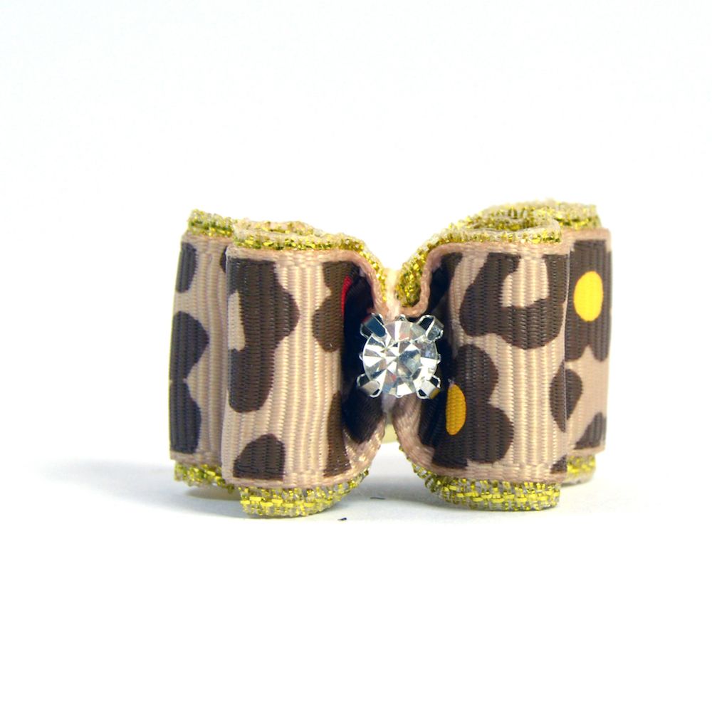 Rhinestone Hair Bow Close-up of a tan rhinestone hair bow featuring leopard print fabric with yellow dots and gold glitter trim, adorned with a center rhinestone.